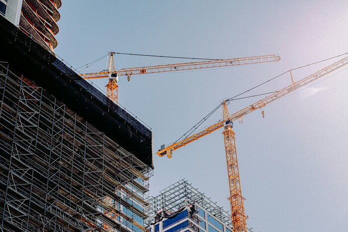 Yellow crane near a building under construction